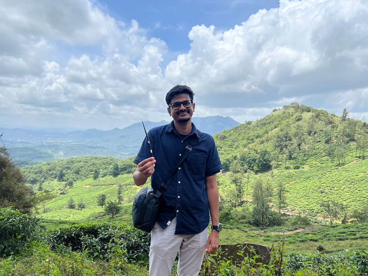 A man is standing with a mountain range in the background. A man is standing with a mountain range in the background.