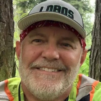 Portrait of Gary Roloff in front of trees.